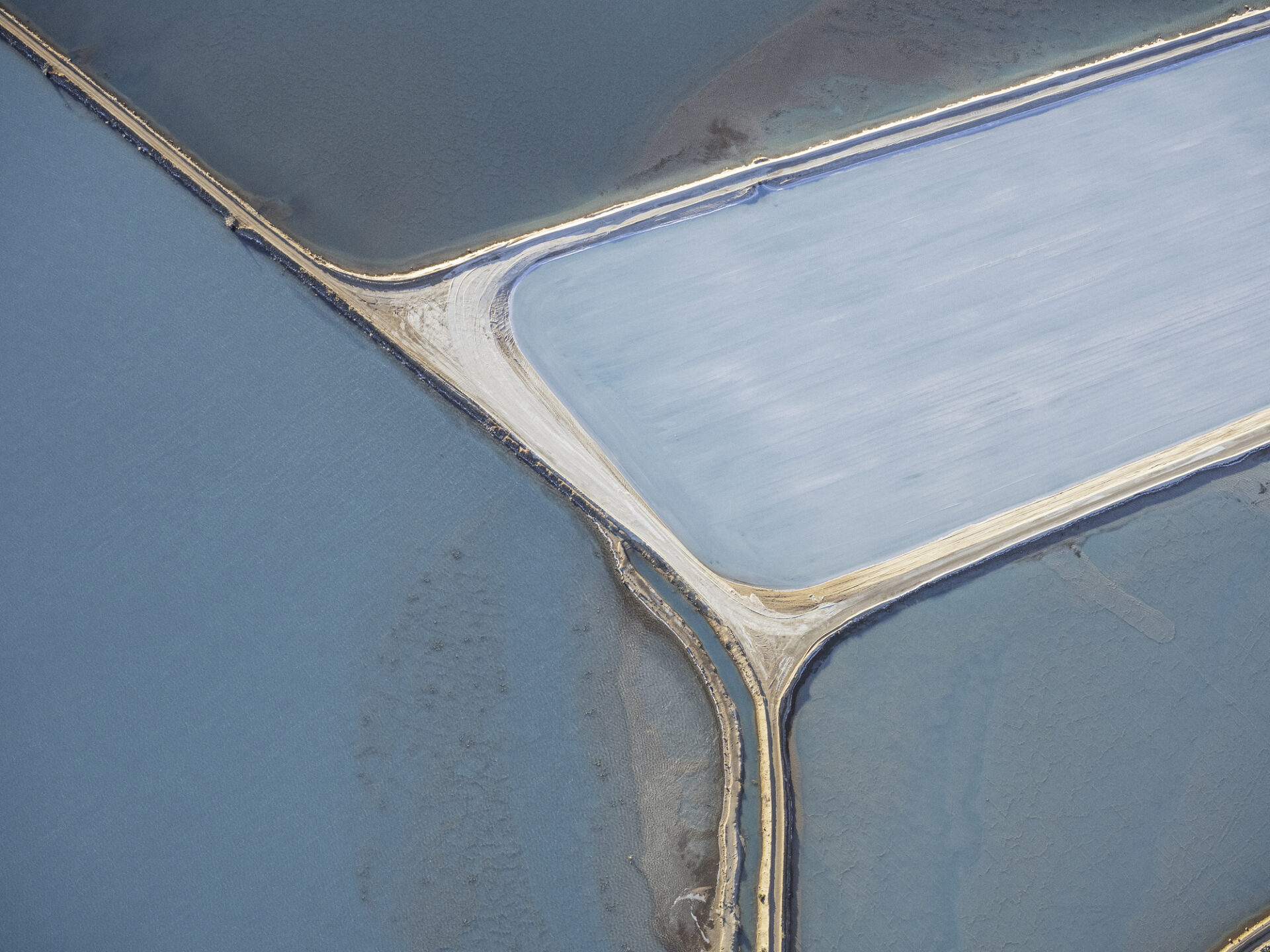 Aerial photo taken from a small plane showing a patchwork quilt of the salt works below.